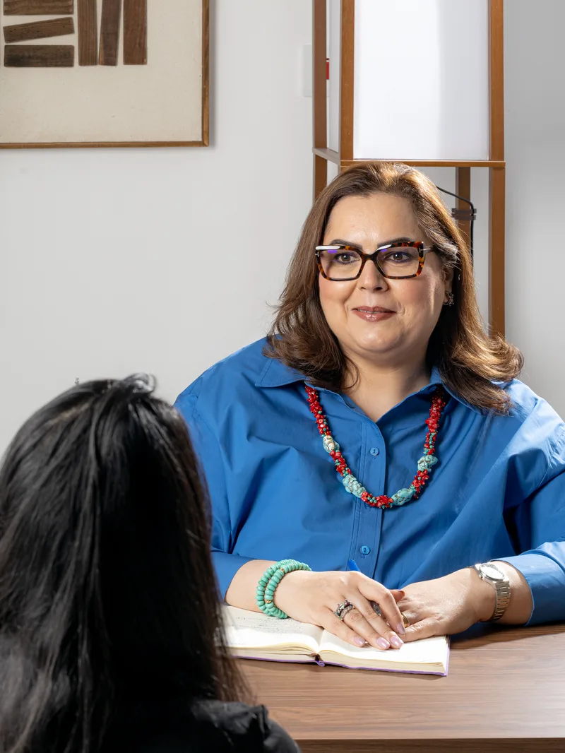 Rula in a one-to-one coaching conversation across the table